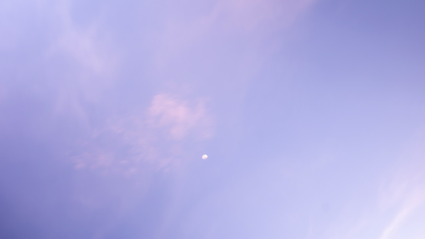 Moon on sunset sky, purple sky, clouds moving, time lapse