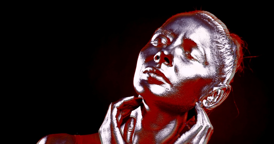 female portrait. the woman has closed eyes and is touching her head and neck with hands. the image is split. the colors change