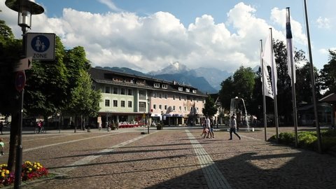 Garmisch-Partenkirchen, Germany - July 7, 2018: A view of the city center on a beautiful summer day. The Alpine mountains are in the background, including the Zugspitze and Alpspitze mountains. 