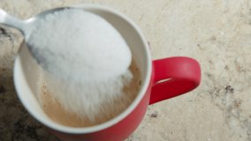 Slow Motion Close Up of a Black Man Hand, Who Stirs White Sugar into Red Cup of Freshly Made Coffee With A Spoon 4k 60fps - Powered by Shutterstock - Get 15% off with code: PIKWIZARD15