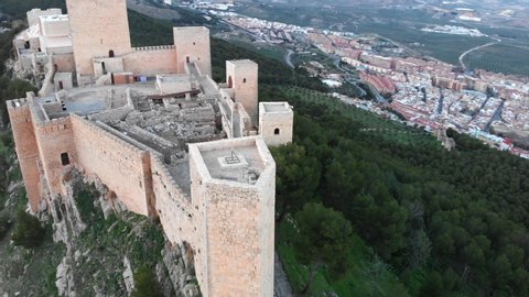 Jaen's Castle Saint Catalina Castle Spain shoot with a drone at 4k 24fps showing the exterior and the city from multiple points on a afternoon in December.