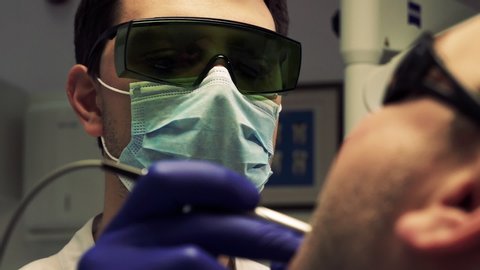 dentist examines a patient's oral cavity with previously prepared modern tools