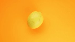 Abstract color animation of moving lemon on orange background