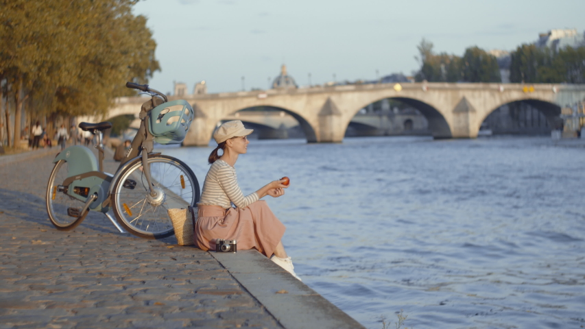 Young girl with a bicycle in the city, Paris