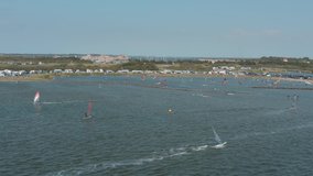 Drone / Aerial shot of many surfers on a blue, wavy and windy sea on a sunny day with white clouds on a island, Zeeland, Netherlands, 30p - Powered by Shutterstock - Get 15% off with code: PIKWIZARD15