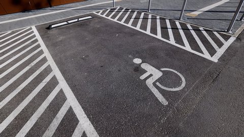separated disabled signs on asphalt parking lots near shopping centre or mall