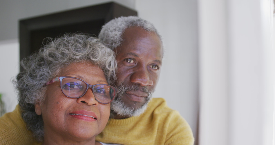 A senior African American couple spending time at home together, social distancing and self isolation in quarantine lockdown during coronavirus covid 19 epidemic, embracing, smiling in slow motion Royalty-Free Stock Footage #1050898441