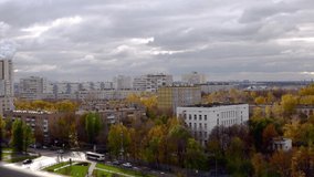time laps video from the 10th floor to a sleeping area of Moscow autumn day. Moscow time lapse crossroads with cars and people, changing light on colorful trees
