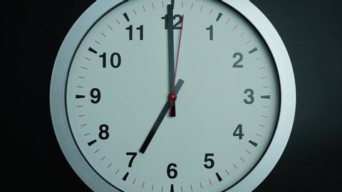 Closeup Zoom out, Gray wall clock shows time 7 o'clock on black background, Time lapse 60 minutes moving fast, Time concept.