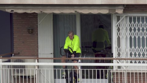 Cyclist in balcony during Coronavirus Lockdown to Boost Morale. Spain. March 2020