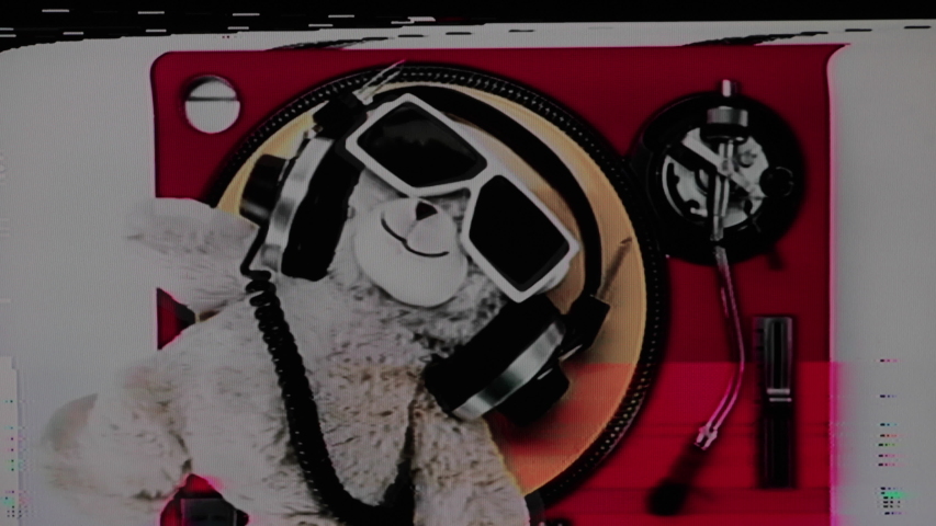 a cool DJ teddy bear with headphones lying spinning crazily back and forth on top of pink turntable with yellow vinyl with video glitch and distortion