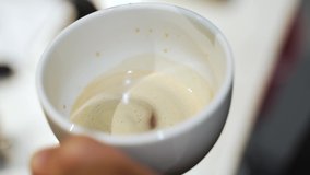 Pouring of milk into a double shot espresso. This was taken at a higher frame rate and has been converted to a slow motion video clip.