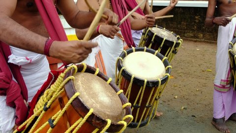 Unidentified Indian men play traditional percussion instrument Chenda during temple festival in Kerala state, Southern India 