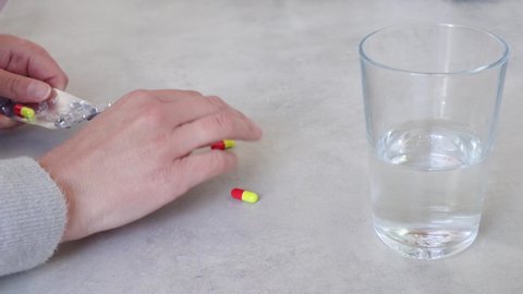 female hand takes paracetamol tablets. coronavirus pandemic concept