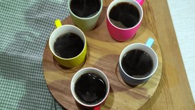 Rotation of the set of hot Black coffee mugs .
