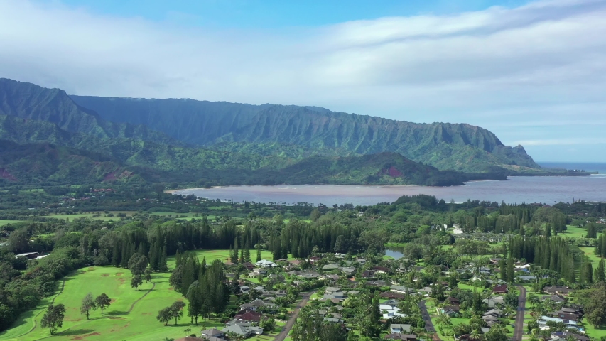 Princeville Hanalei bay in aerial drone from. Overview of vacation and luxurious homes and nature mountains range in background. Ocean view on beautiful morning. Kauai Hawaiian islands