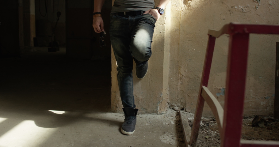 Young guy stands in an abandoned building
