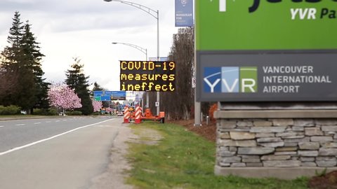 RICHMOND, BC, CANADA - MAR 29, 2020: An electronic road sign at YVR airport displaying public health notices related to the COVID-19 coronavirus pandemic.