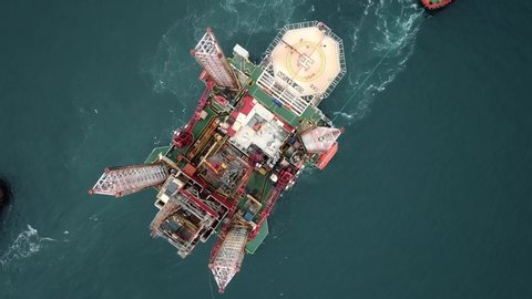 ISTANBUL - CIRCA 2018: Top down view of a towing convoy consisting of a superstructure of a technological oil platform and tow boats. Tugboats maneuver the offshore drilling rig under Bosphorus Bridge
