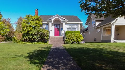 Small suburban home exterior approach; dolly shot