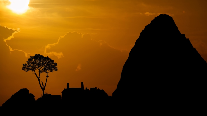 Machu Picchu: Ruins of Ancient Inca City, Time Lapse at Sunset with Red Clouds, Fiery Sky and Dark Silhouette of Mountains, Peru