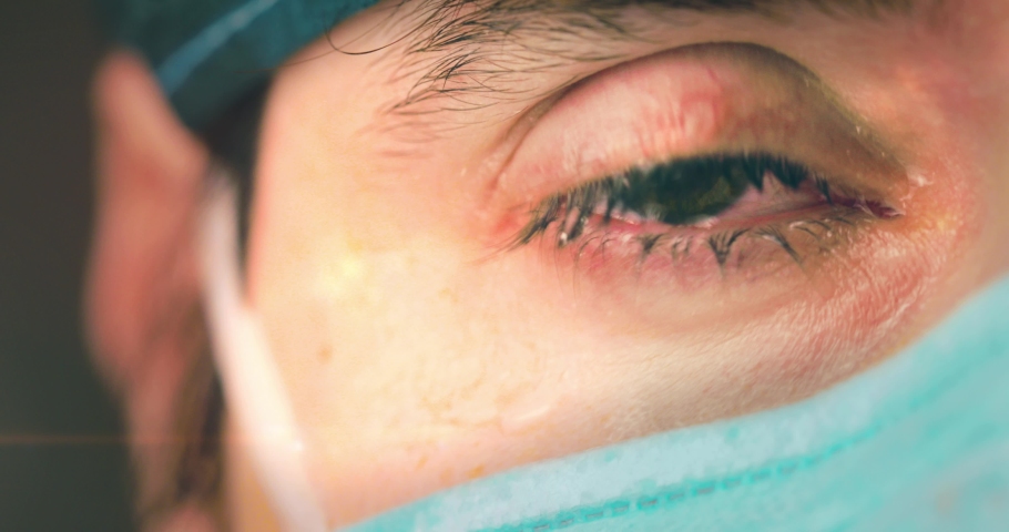 Eyes of a doctor or nurse as she cries after a grueling shift to treating Coronavirus patients in the intensive care unit. Royalty-Free Stock Footage #1050996706