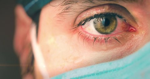 Eyes of a doctor or nurse as she cries after a grueling shift to treating Coronavirus patients in the intensive care unit.