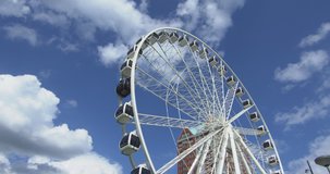 Time lapse of a ferris wheel with moving clouds in the background. Attraction in the middle of the centre at Rotterdam. 
