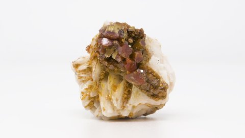 Extremely close view of Vanadinite crystals on Barite mineral. Rotating completely. Looping