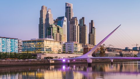 Buenos Aires, Argentina - February 02, 2020: Day to night timelapse view of Puerto Madero including architectural landmark Puente de la Mujer in Buenos Aires, Argentina, zoom out.