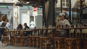 Young girl sitting in a cafe in Paris in the morning