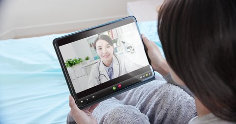 telemedicine concept - asian female patient use tablet pc to see the doctor