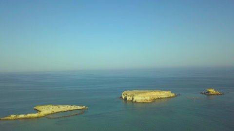 Panoramic view from the drone of the small rocky islands in the Persian Hall. Video made from Qeshm island, Iran. You can see the calm blue sea, horizon, cloudless sky. The camera moves back.