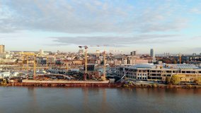 Drone video of a large construction site on the waterfront of river Sava in Belgrade, Serbia. City skyline.