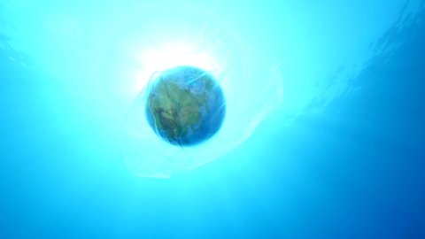 world in plastic bag ocean pollurion underwater sun beams and rays 