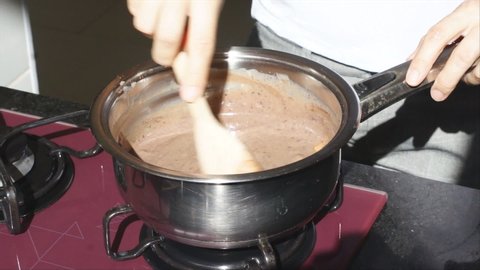 Woman preparing a chocolate dessert called brigadeiro