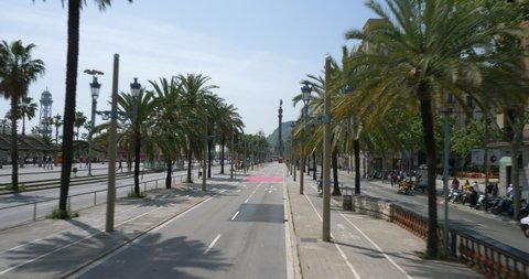 BARCELONA, SPAIN - APRIL 2018: Riding Barcelona,s double-decker bus through Passeig de Colom palm trees street in the hart of the city, Spain