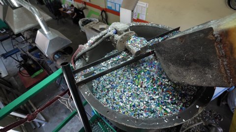  flakes are transported to a container for melting. Recycling Plastic Bottles