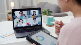 Back view of business woman talking about sale report in video conference.Asian team using laptop and tablet online meeting in video call.Working from home, Working remotely and Self isolation at home - Powered by Shutterstock - Get 15% off with code: PIKWIZARD15