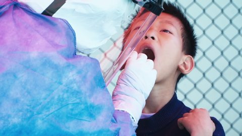 Wuhan, Hubei Province / China - Feb 23 2020: Coronavirus medic conducts throat swab test 