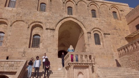 Midyat, Mardin, Turkey - January 2020: Tourists visiting Mor Gabriel Deyrulumur Monastry is the oldest surviving Syriac Orthodox monastery in the world.