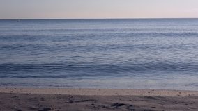 Calm sea, video recorded at sunrise on a beach in Sueca (Spain) in January 2019