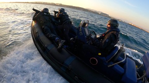 ALICANTE, SPAIN – MARCH 10, 2020. Sailors of Spanish Customs training on board of a rhib of the coast guard  named ARAO sailing next to the port of Alicante.