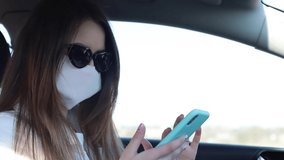 Video blogs of girls about the covid-19 pandemic, a student with a smartphone gets a lot of likes, sitting in a mask in her car. Happy novice blogger in social networks