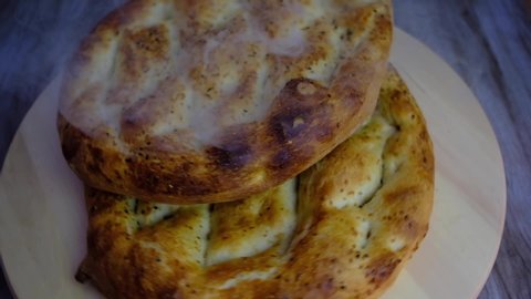 Topview of Ramadan Kareem concept video, close-up of hot pita bread with smoke in slowmo rotate