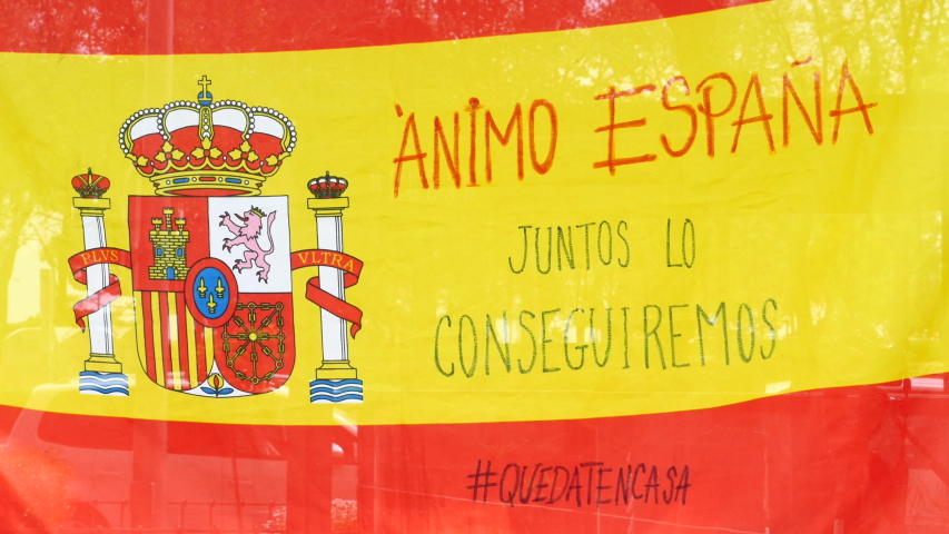 Spanish flag with the message "ANIMO ESPAÑA, JUNTOS LO CONSEGEMEMEM" hung in a Madrid venue due to the state of alarm in Spain by COVID-19. Filmed on April 24, 2020.