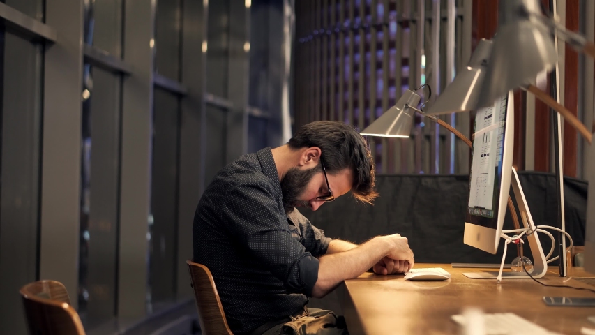 Tired Businessman Sleeping On Workplace.Frustrated Businessman Working Alone.Workaholic Overtime Overworked In Internet At Deadline.Tired Businessman In Night Office.Overwhelmed Exhausted Stressed Man | Shutterstock HD Video #1051116352