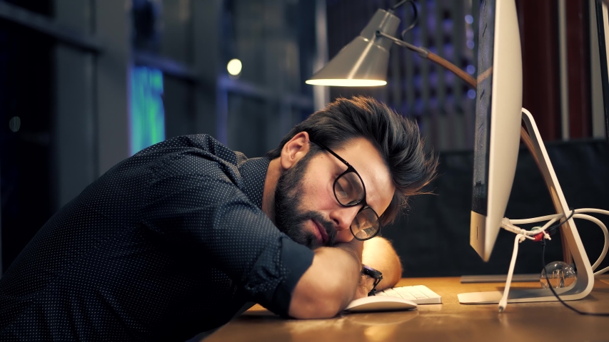 Tired Businessman Sleeping On Workplace.Frustrated Businessman Working Alone.Workaholic Overtime Overworked In Internet At Deadline.Tired Businessman In Night Office.Overwhelmed Exhausted Stressed Man | Shutterstock HD Video #1051117585