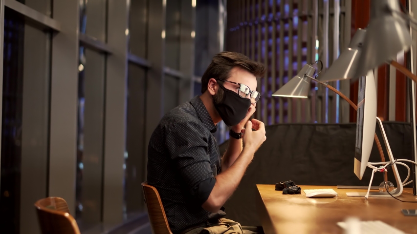 Businessman Wearing Face Mask.Man Puts On Face Mask.Remote Office Internet Online Meeting Conference Webinar.Businessman In Mask Protection Epidemic Covid-19 Coronavirus Quarantine Social Distance Job | Shutterstock HD Video #1051118860