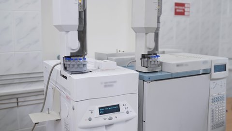Automated laboratory machine for research scientist analyzes test tube. Laboratory of food industry measurement of alcoholic beverages production parameters in flasks and test tubes.